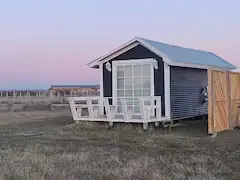 Cabaña Magia al atardecer con tonos rosados en el cielo de la Patagonia chilena